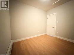 Neutral wall finishes complement the wood-finish flooring - 