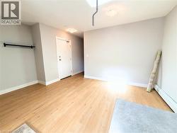 Light wood-finish flooring extends throughout this space, complemented by neutral wall tones - 