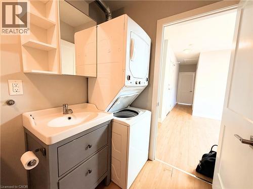 Dedicated laundry area featuring a stacked washer and dryer unit - 310 Barton Street E Unit# A, Hamilton, ON - Indoor Photo Showing Laundry Room