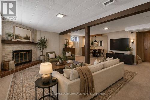 This rec room is virtually staged. - 1582 Digby Street, Ottawa, ON - Indoor Photo Showing Living Room With Fireplace