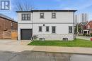 side view with attached garage & concrete driveway - 109 Ray Street N, Hamilton, ON  - Outdoor 