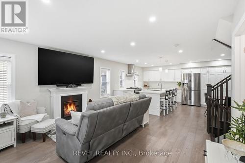 O/C Living rm, 9' ceilings & engineered hrdwd flrs - 109 Ray Street N, Hamilton, ON - Indoor Photo Showing Living Room With Fireplace
