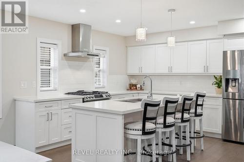 Large island ample storage engineered hardwd flrs - 109 Ray Street N, Hamilton, ON - Indoor Photo Showing Kitchen With Upgraded Kitchen