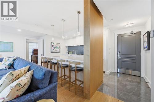 Open-concept living area with wood-finish flooring extending into the kitchen - 2060 Lakeshore Road Unit# 1501, Burlington, ON - Indoor Photo Showing Living Room