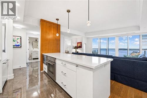 Kitchen island featuring a white countertop and integrated stainless steel appliances - 2060 Lakeshore Road Unit# 1501, Burlington, ON - Indoor Photo Showing Kitchen