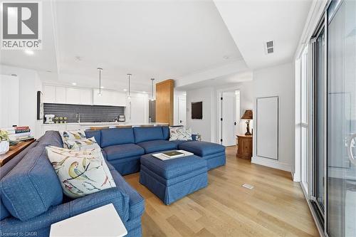 Open-concept living space featuring wood-finish flooring, white walls, and a recessed lighting - 2060 Lakeshore Road Unit# 1501, Burlington, ON - Indoor Photo Showing Living Room