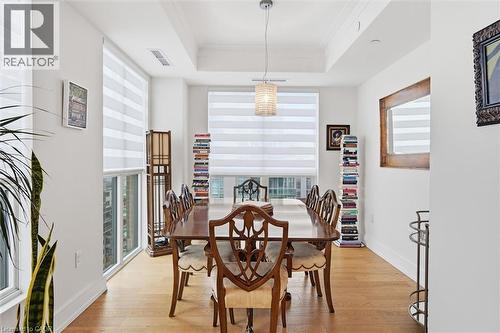 Bright dining area featuring hardwood flooring, recessed lighting, and a tray ceiling - 2060 Lakeshore Road Unit# 1501, Burlington, ON - Indoor Photo Showing Dining Room
