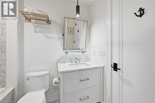White vanity with a marble countertop, undermount sink, and polished chrome faucet - 2060 Lakeshore Road Unit# 1501, Burlington, ON - Indoor Photo Showing Bathroom