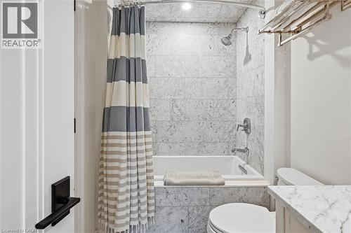 Bathroom featuring a built-in tub and shower combination with stone tile surround - 2060 Lakeshore Road Unit# 1501, Burlington, ON - Indoor Photo Showing Bathroom