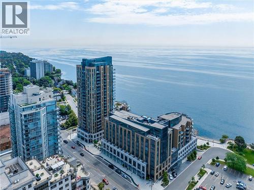Aerial perspective showcasing waterfront properties and urban landscape - 2060 Lakeshore Road Unit# 1501, Burlington, ON - Outdoor With Body Of Water With View