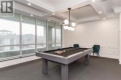 Expansive room with floor-to-ceiling windows, white wainscoting, and recessed lighting - 