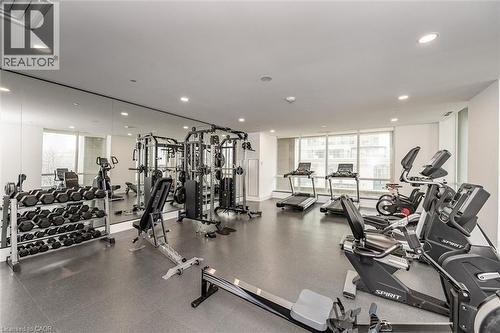 Fitness center featuring a mirrored wall, recessed lighting, and multiple exercise machines - 2060 Lakeshore Road Unit# 1501, Burlington, ON - Indoor Photo Showing Gym Room