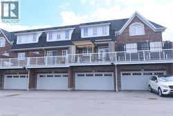 Red brick facade townhome featuring multiple dormer windows - 