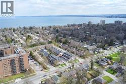 Aerial perspective showcasing a residential area with a prominent body of water in the background - 