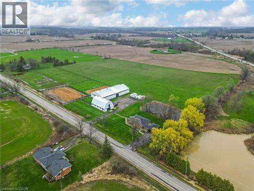 Expansive property featuring multiple outbuildings, agricultural fields, and a pond - 2223 Hall Road, Binbrook, ON - Outdoor With View