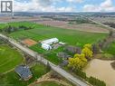 Expansive property featuring multiple outbuildings, agricultural fields, and a pond - 2223 Hall Road, Binbrook, ON  - Outdoor With View 