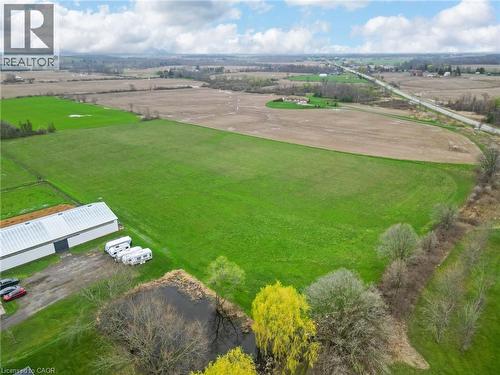 Expansive green pastureland with a large barn structure - 2223 Hall Road, Binbrook, ON - Outdoor With View
