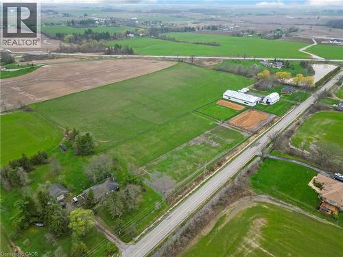 Expansive agricultural property featuring cultivated fields and a paved road frontage - 2223 Hall Road, Binbrook, ON - Outdoor With View