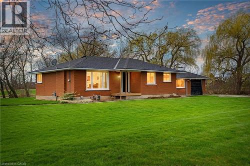 Brick exterior residence with a dark shingle roof and a spacious lawn - 2223 Hall Road, Binbrook, ON - Outdoor