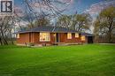 Brick exterior residence with a dark shingle roof and a spacious lawn - 2223 Hall Road, Binbrook, ON  - Outdoor 