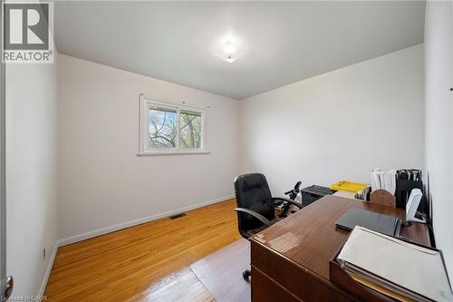 Room featuring wood-finish flooring, white walls, a single window, and a flush-mount ceiling light fixture - 2223 Hall Road, Binbrook, ON - Indoor Photo Showing Office