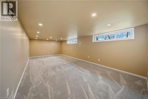 Spacious room featuring light-toned carpeting, recessed ceiling lighting, and multiple egress windows - 2223 Hall Road, Binbrook, ON - Indoor Photo Showing Other Room