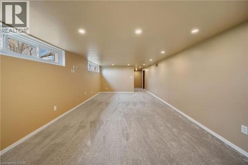 Spacious room featuring new carpet, recessed lighting, and perimeter windows - 2223 Hall Road, Binbrook, ON - Indoor Photo Showing Other Room