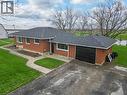 Brick exterior with a dark shingle roof and an attached garage - 2223 Hall Road, Binbrook, ON  - Outdoor 