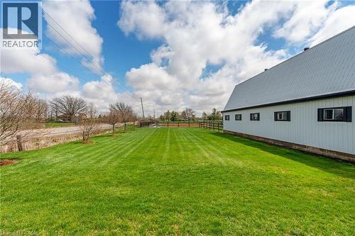 White-sided outbuilding with black-trimmed windows and a metal roof - 2223 Hall Road, Binbrook, ON - Outdoor