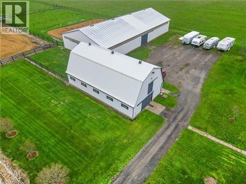 Expansive property featuring two large barns with metal roofs and multiple bay doors - 2223 Hall Road, Binbrook, ON - Outdoor