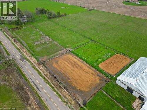 Expansive agricultural property featuring multiple fenced paddocks, a large riding arena, and a substantial outbuilding with a metal roof - 2223 Hall Road, Binbrook, ON - Outdoor With View