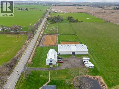 Expansive rural property featuring multiple outbuildings, including a large white barn with a silver roof - 2223 Hall Road, Binbrook, ON - Outdoor With View