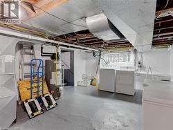 Spacious utility area featuring a water heater, washer, and dryer - 