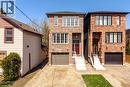 Brick facade home featuring a single garage, a red front door, white trimmed windows, and a paved driveway - 128 Canada Street, Hamilton, ON  - Outdoor 