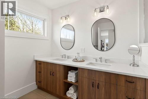 Dual vanity featuring wood-finish cabinetry and white countertops - 128 Canada Street, Hamilton, ON - Indoor Photo Showing Bathroom