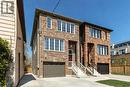 Brick facade townhouse featuring white-framed windows, an attached garage, and a concrete driveway - 128 Canada Street, Hamilton, ON  - Outdoor With Facade 