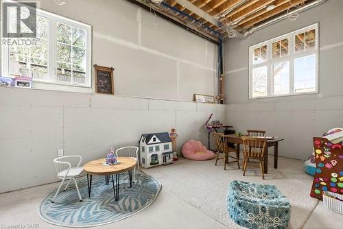 Unfinished lower level with two large windows - 128 Canada Street, Hamilton, ON - Indoor Photo Showing Other Room