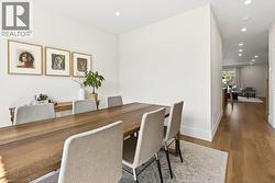 Dining area with recessed lighting, light wood-finish flooring, and white baseboards - 