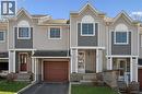 Contemporary townhome exterior featuring light-toned siding with dark grey shingle accents and white trim - 365 Pioneer Drive Unit# 25, Kitchener, ON  - Outdoor With Facade 