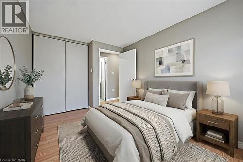 Well-lit interior space featuring wood-finish flooring and light gray painted walls - 365 Pioneer Drive Unit# 25, Kitchener, ON - Indoor Photo Showing Bedroom