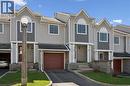 Townhome exterior featuring light gray siding with dark gray shingle accents and white trim - 365 Pioneer Drive Unit# 25, Kitchener, ON  - Outdoor With Facade 