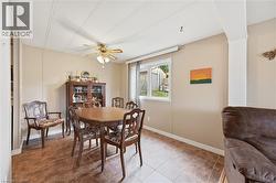 Dining area featuring tile flooring, a window, and a ceiling fan - 