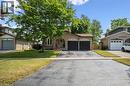 Brick exterior with a prominent mature tree and a two-car attached garage - 97 Bechtel Drive, Kitchener, ON  - Outdoor With Facade 
