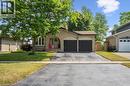 Brick exterior featuring a two-car garage with black doors, an arched entryway, and a bay window - 97 Bechtel Drive, Kitchener, ON  - Outdoor With Facade 