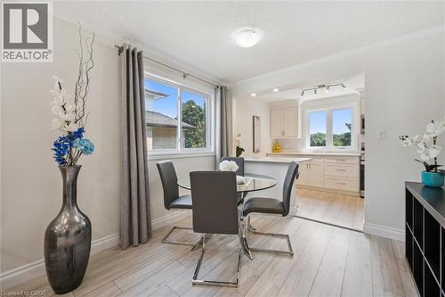 Dining area featuring wood-finish flooring, a large window with natural light, and crown molding - 97 Bechtel Drive, Kitchener, ON - Indoor Photo Showing Other Room