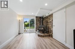 Bright living area featuring wood-finish flooring and recessed lighting - 