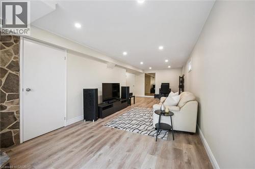 Spacious room featuring wood-finish flooring, recessed lighting, and light-toned walls - 97 Bechtel Drive, Kitchener, ON - Indoor