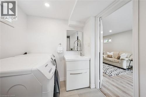 Laundry area featuring a compact vanity with a vessel sink and pull-down faucet, a mirrored medicine cabinet, and recessed ceiling lighting - 97 Bechtel Drive, Kitchener, ON - Indoor Photo Showing Laundry Room