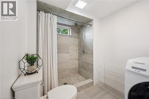 Shower with light grey tile surround, recessed window, and white shower curtain - 97 Bechtel Drive, Kitchener, ON - Indoor Photo Showing Other Room
