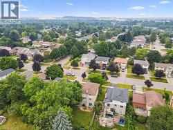 Aerial perspective showcasing a residential neighborhood with mature trees - 